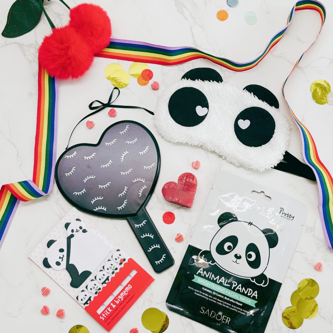 Collection of panda-themed products including a mask, stickers, and a pouch on a white background.