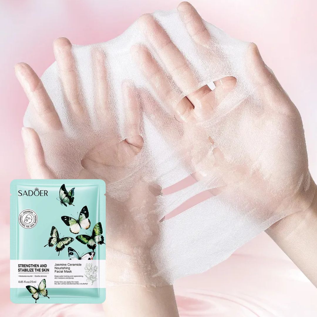 Hands applying a face mask with SADOER packaging on a pink background