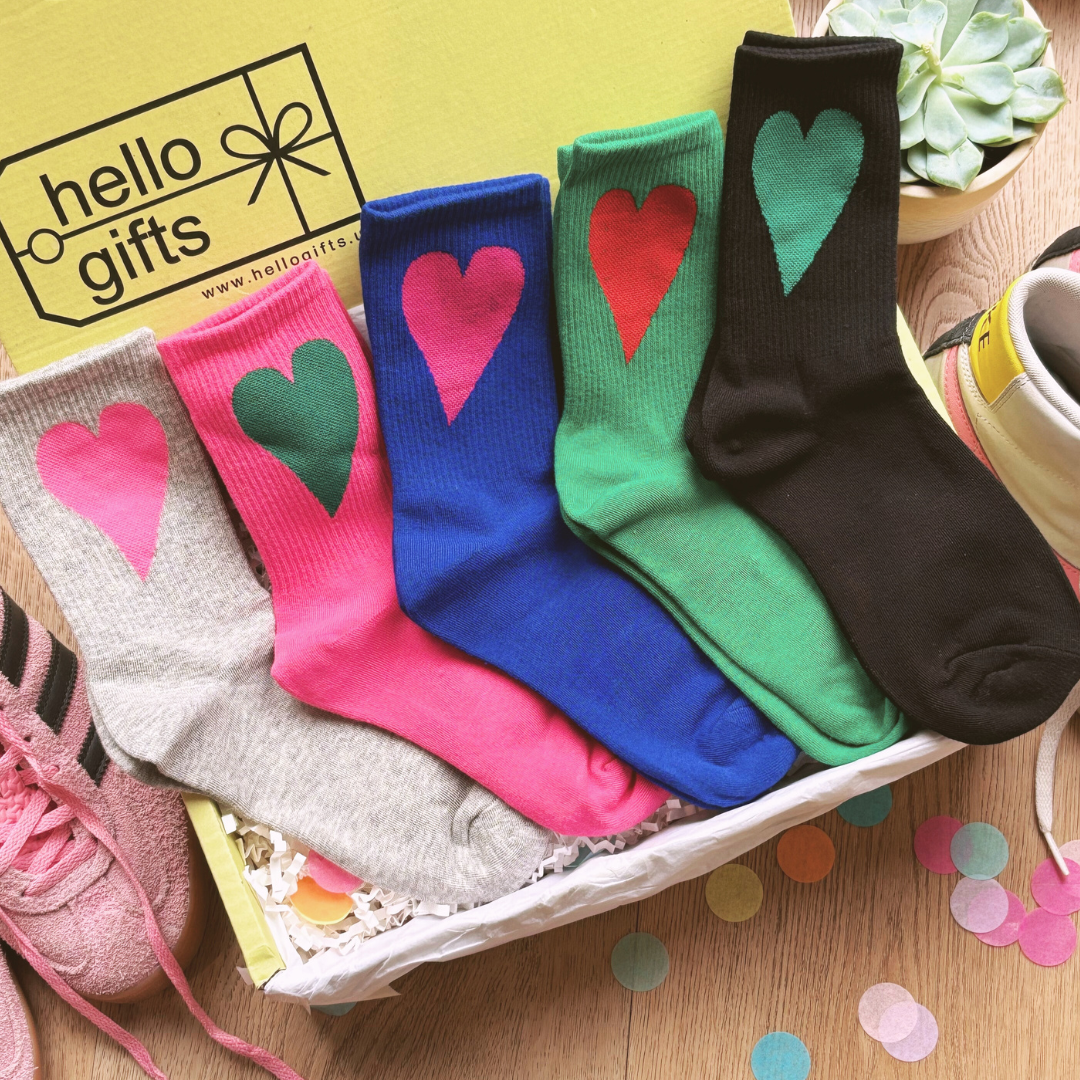 Sock gift box. A selection of colourful socks each featuring a heart in a different colour, displayed in a gift box.