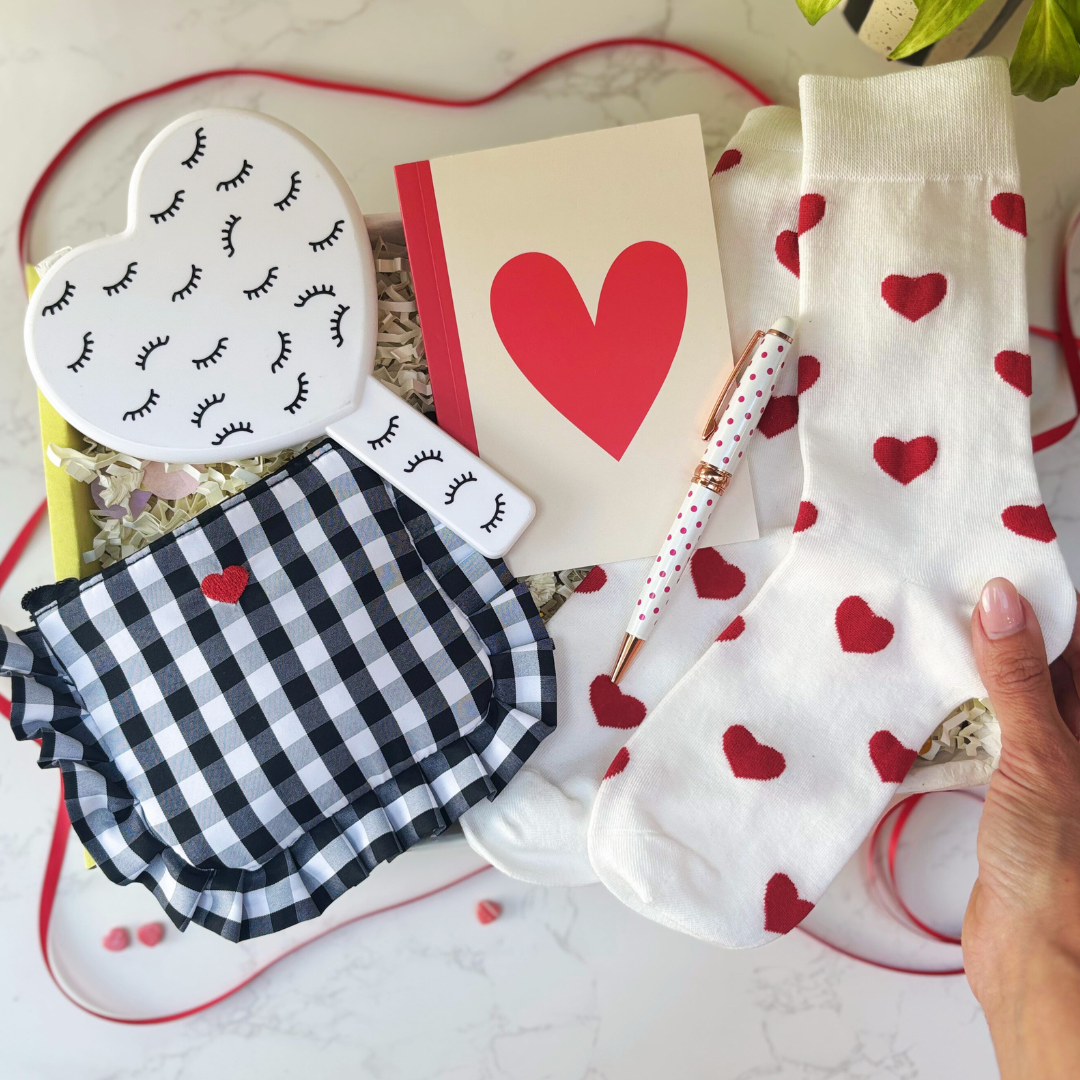 Heart-themed gift box including mirror, purse, notebook, pen and socks, in a giftbox.