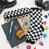 A flat-lay gift set featuring black and white checkered socks and a matching zippered pouch, displayed with a black notebook, blue pen, hamburger keychain, and colorful enamel pins on a white background.