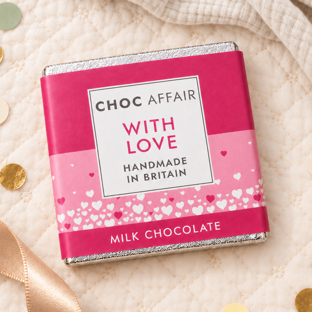 A wrapped milk chocolate bar from Choc Affair, featuring a bright pink and light pink wrapper with white hearts and the text &