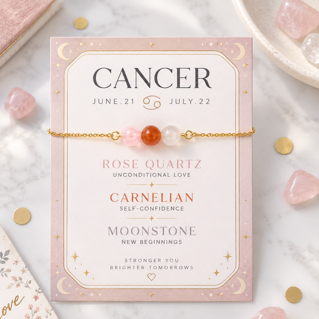 A gold beaded bracelet with pink, orange, and white rose quartz beads is displayed on its pink card packaging, which features astrological details for Cancer. The card is styled on a white marble surface with scattered rose quartz crystals and gold coins.