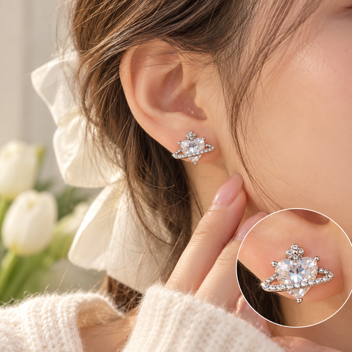 A close-up lifestyle shot of a model wearing a silver-toned space-themed stud earring with a clear faceted gemstone. The image features a main view of the earring on the ear, and a circular inset zoom-in showing the detailed crystal structure.